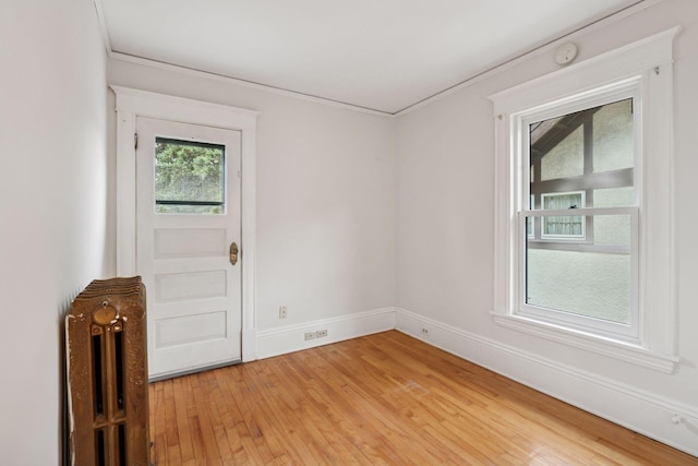 3252 Aldrich Ave S, Minneapolis, MN 55408 - empty room with light wood-style flooring, a smoke detector, baseboards, and ornamental molding