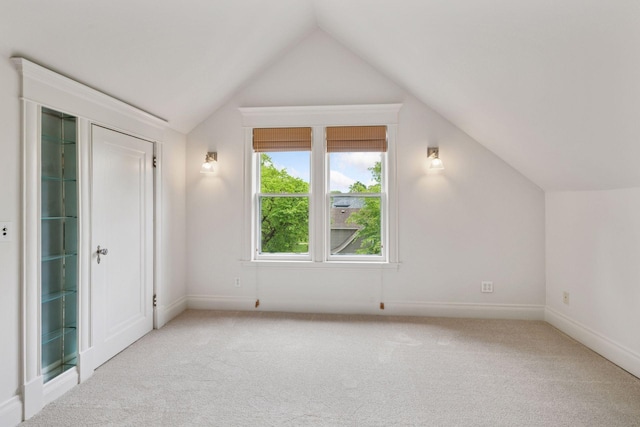 3252 Aldrich Ave S, Minneapolis, MN 55408 - unfurnished bedroom with light carpet, lofted ceiling, and baseboards