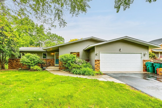 947 Dawn Ave, Shoreview, MN 55126 - mid-century modern home featuring an attached garage, driveway, a front lawn, and brick siding