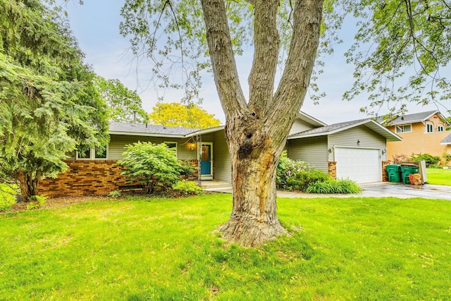 947 Dawn Ave, Shoreview, MN 55126 - view of front facade with a front lawn, an attached garage, concrete driveway, and brick siding