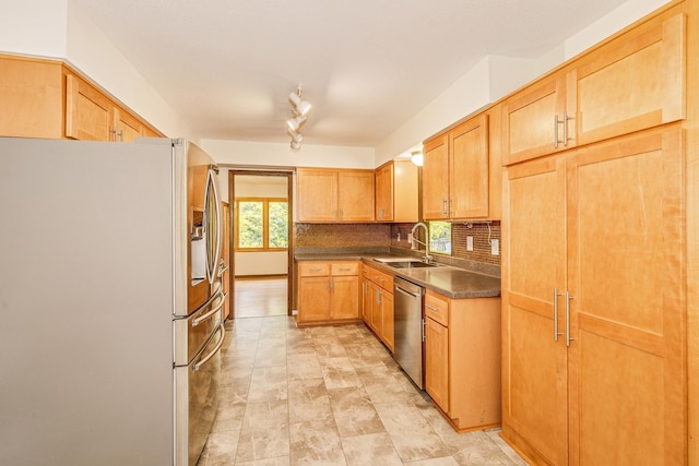 947 Dawn Ave, Shoreview, MN 55126 - kitchen with appliances with stainless steel finishes, a sink, tasteful backsplash, and dark countertops