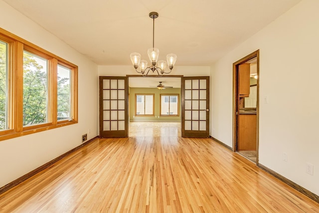 947 Dawn Ave, Shoreview, MN 55126 - unfurnished room featuring light wood-type flooring, a chandelier, baseboards, and a ceiling fan