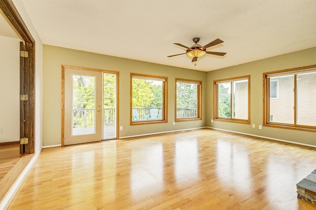 947 Dawn Ave, Shoreview, MN 55126 - empty room with light wood finished floors, ceiling fan, and baseboards