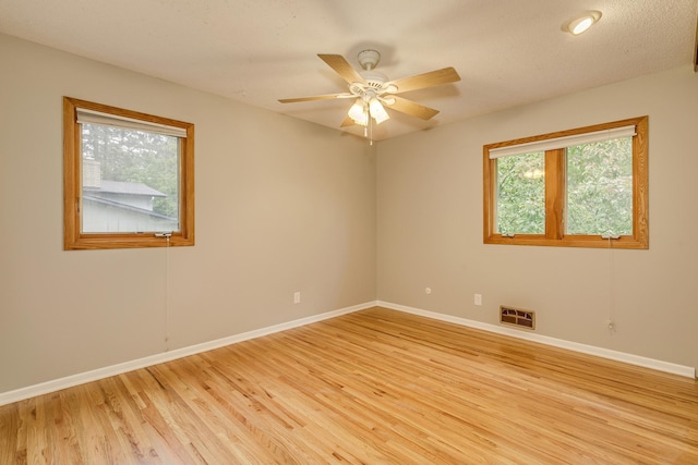947 Dawn Ave, Shoreview, MN 55126 - unfurnished room featuring healthy amount of natural light, light wood-style flooring, and baseboards