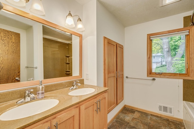 947 Dawn Ave, Shoreview, MN 55126 - bathroom with a shower, double vanity, baseboards, a textured ceiling, and a tub to relax in