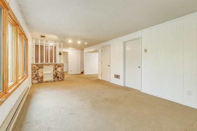 947 Dawn Ave, Shoreview, MN 55126 - carpeted spare room with baseboard heating and track lighting