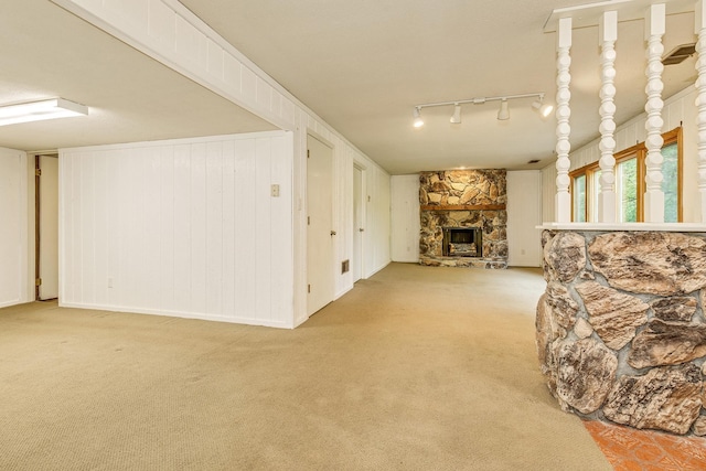 947 Dawn Ave, Shoreview, MN 55126 - living room featuring a stone fireplace, light colored carpet, and track lighting