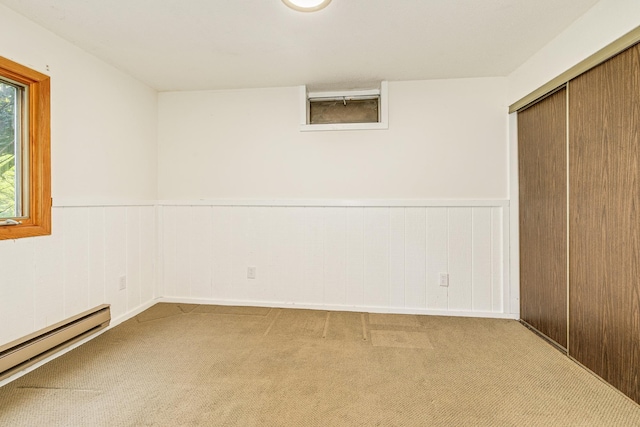 947 Dawn Ave, Shoreview, MN 55126 - unfurnished bedroom featuring a baseboard radiator, carpet, a closet, and wainscoting