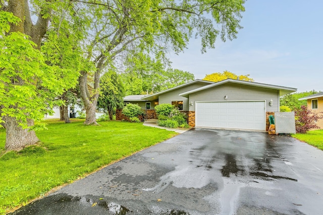 947 Dawn Ave, Shoreview, MN 55126 - view of front of home with asphalt driveway, an attached garage, and a front lawn