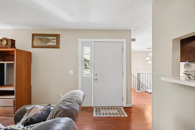 383 Elan Ct, Woodbury, MN 55125 - entrance foyer featuring wood finished floors and a textured ceiling