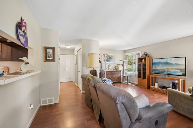 383 Elan Ct, Woodbury, MN 55125 - living area featuring wood finished floors, a textured ceiling, and baseboards