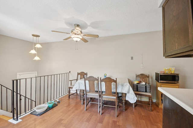 383 Elan Ct, Woodbury, MN 55125 - dining room with a ceiling fan, wood finished floors, and a textured ceiling