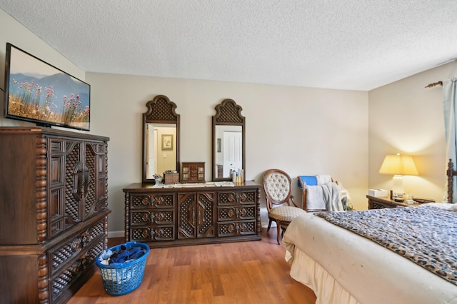 383 Elan Ct, Woodbury, MN 55125 - bedroom with wood finished floors and a textured ceiling