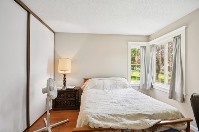 383 Elan Ct, Woodbury, MN 55125 - bedroom with a textured ceiling and wood finished floors