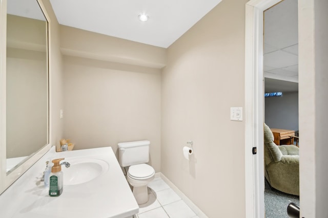 383 Elan Ct, Woodbury, MN 55125 - ensuite bathroom featuring toilet, vanity, tile patterned flooring, and baseboards