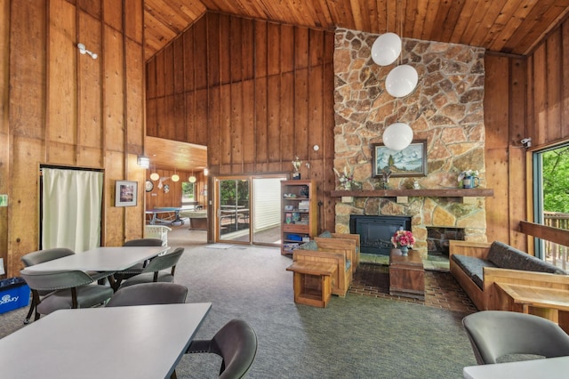 383 Elan Ct, Woodbury, MN 55125 - carpeted living area with high vaulted ceiling, wooden walls, wooden ceiling, and a stone fireplace