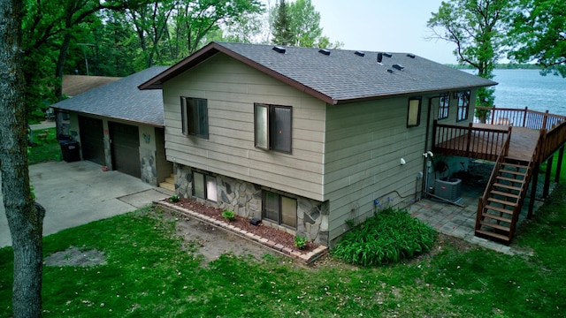 34347 Northview Rd, Everts Twp, MN 56515 - back of house with a shingled roof, stairway, a deck with water view, and a yard