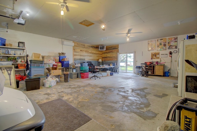 34347 Northview Rd, Everts Twp, MN 56515 - garage featuring ceiling fan, a garage door opener, an AC wall unit, and a workshop area