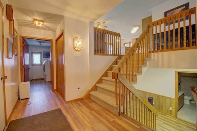 34347 Northview Rd, Everts Twp, MN 56515 - stairs with washer / clothes dryer, a ceiling fan, wood finished floors, and baseboards