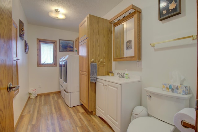 34347 Northview Rd, Everts Twp, MN 56515 - bathroom featuring wood finished floors, vanity, toilet, baseboards, and a textured ceiling