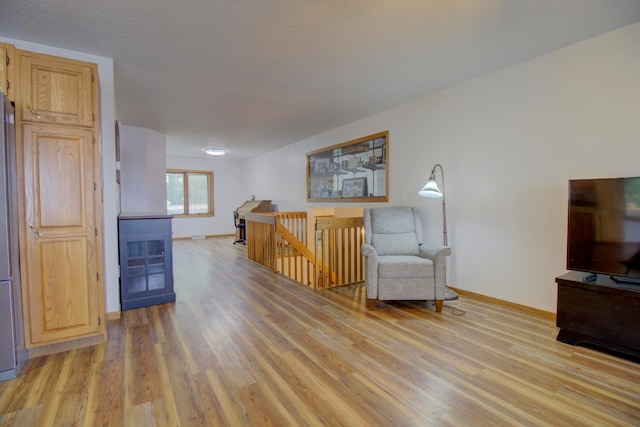 34347 Northview Rd, Everts Twp, MN 56515 - sitting room featuring an upstairs landing, light wood finished floors, and baseboards