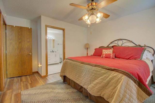 34347 Northview Rd, Everts Twp, MN 56515 - bedroom with wood finished floors, connected bathroom, and ceiling fan