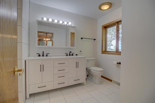 34347 Northview Rd, Everts Twp, MN 56515 - bathroom with double vanity, toilet, baseboards, and tile patterned flooring
