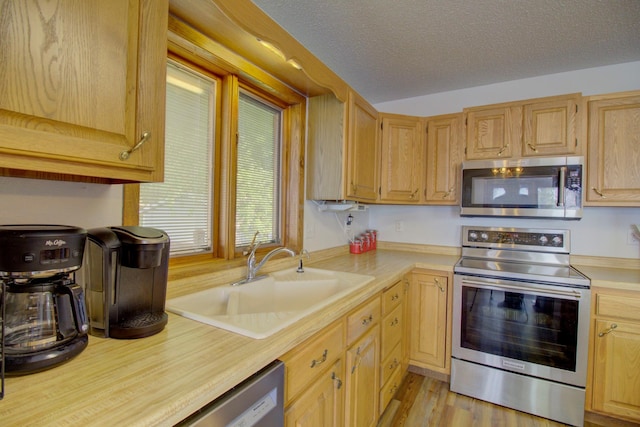 34347 Northview Rd, Everts Twp, MN 56515 - kitchen with appliances with stainless steel finishes, a sink, light countertops, and a textured ceiling