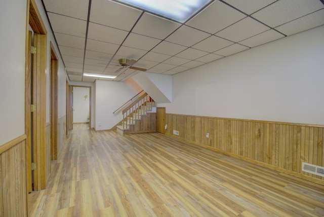 34347 Northview Rd, Everts Twp, MN 56515 - finished basement with wood finished floors, wainscoting, stairway, wooden walls, and a drop ceiling