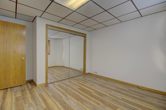 34347 Northview Rd, Everts Twp, MN 56515 - unfurnished bedroom with light wood-style flooring, a drop ceiling, baseboards, and a closet