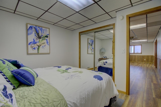 34347 Northview Rd, Everts Twp, MN 56515 - bedroom with a drop ceiling, wood finished floors, wood walls, and a closet