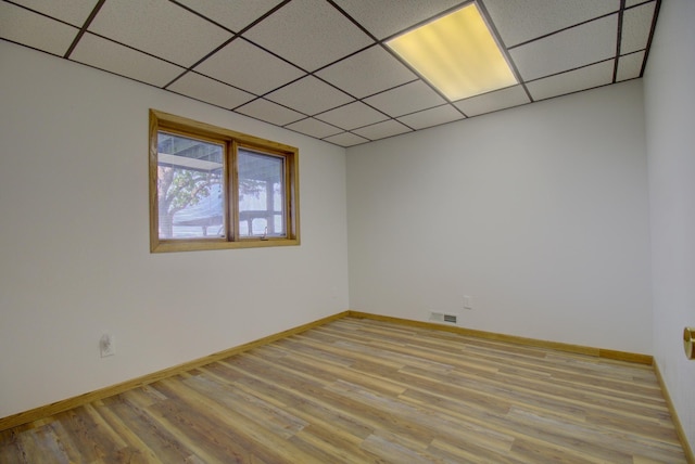 34347 Northview Rd, Everts Twp, MN 56515 - empty room featuring light wood-type flooring, a paneled ceiling, and baseboards