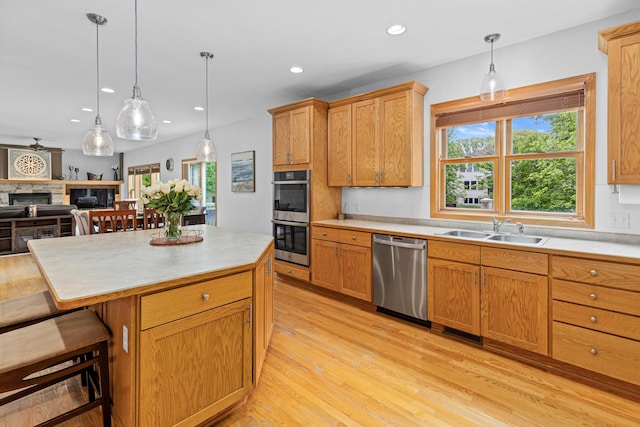 441 Lyman Blvd, Chanhassen, MN 55317 - kitchen with appliances with stainless steel finishes, a sink, recessed lighting, light countertops, and light wood-style flooring