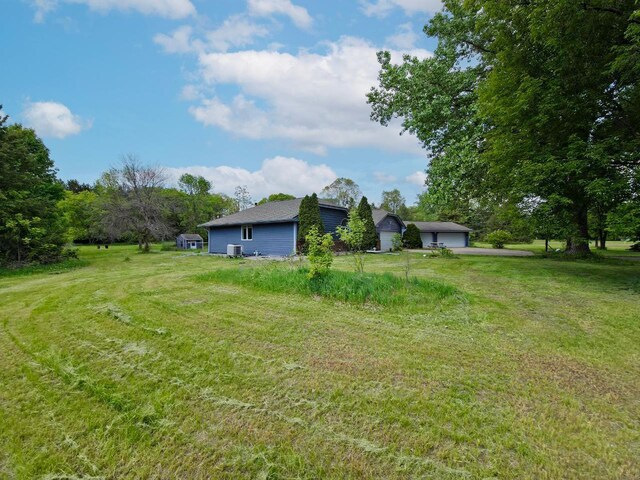 15710 Fox St NW, Andover, MN 55304 - view of grassy yard with a garage