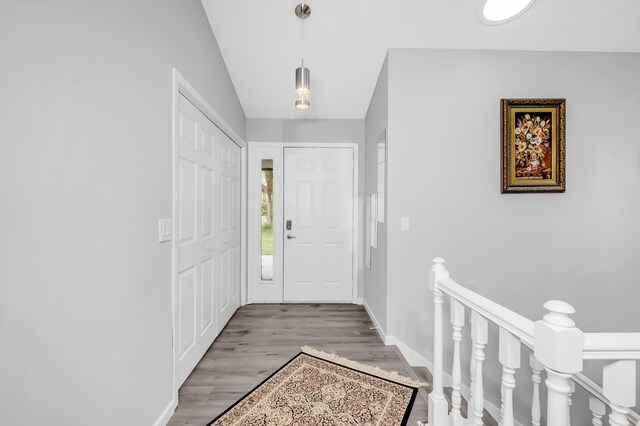 15710 Fox St NW, Andover, MN 55304 - entrance foyer featuring wood finished floors, baseboards, and lofted ceiling