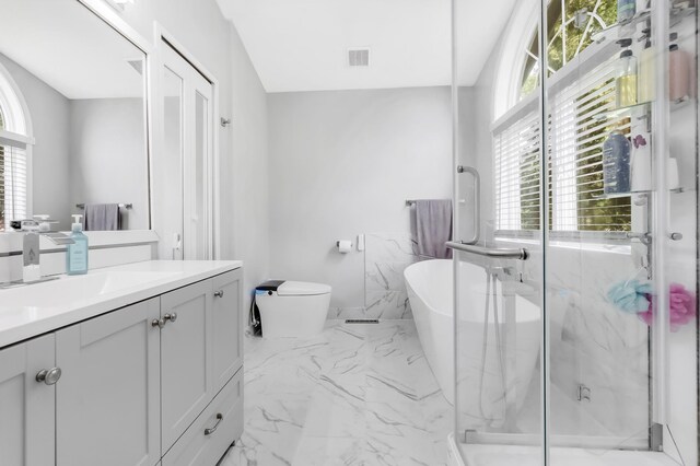 15710 Fox St NW, Andover, MN 55304 - full bath featuring marble look tiles, vanity, a marble finish shower, a freestanding bath, and toilet