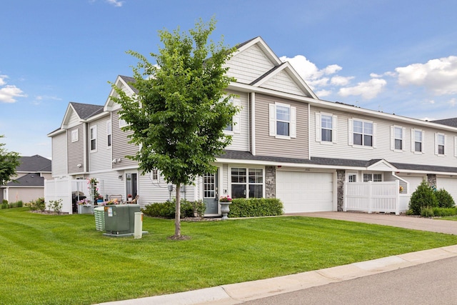 8061 Abercrombie Ln, Woodbury, MN 55129 - view of property featuring asphalt driveway, a front lawn, an attached garage, and stone siding