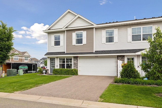 8061 Abercrombie Ln, Woodbury, MN 55129 - view of front of home with driveway, a front lawn, stone siding, and a garage