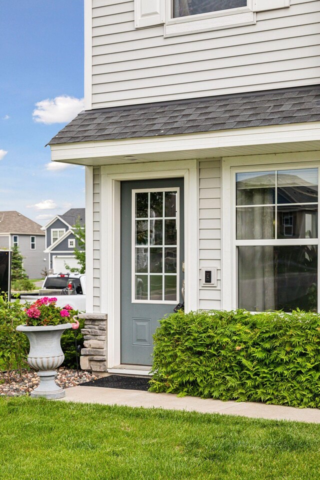 8061 Abercrombie Ln, Woodbury, MN 55129 - view of exterior entry featuring roof with shingles