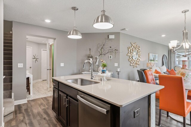8061 Abercrombie Ln, Woodbury, MN 55129 - kitchen with stainless steel dishwasher, a sink, dark wood finished floors, light countertops, and a textured ceiling