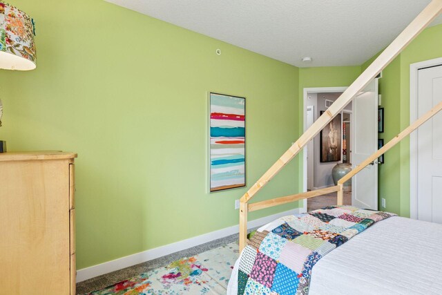8061 Abercrombie Ln, Woodbury, MN 55129 - carpeted bedroom featuring baseboards and a textured ceiling