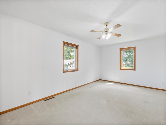 701 Janes Circle Dr SW, Alexandria, MN 56308 - carpeted empty room with healthy amount of natural light, baseboards, and ceiling fan