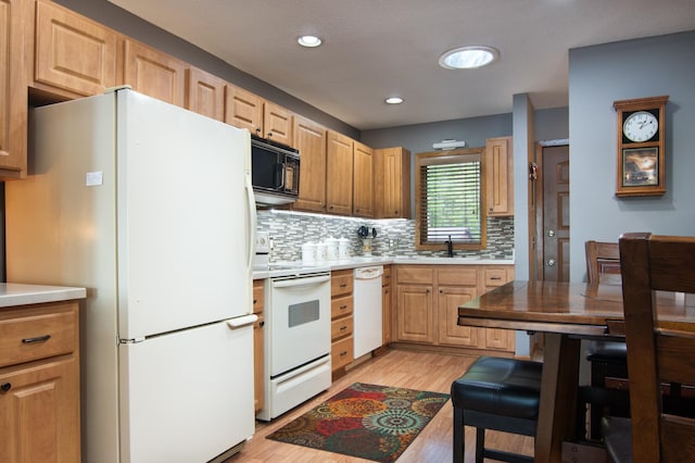215 Park Dr Unit 4, Balsam Lake, WI 54810 - kitchen with white appliances, a sink, tasteful backsplash, light wood-type flooring, and recessed lighting