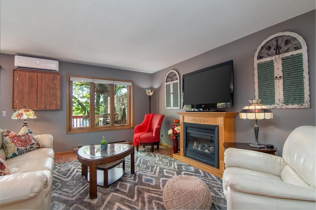 215 Park Dr Unit 4, Balsam Lake, WI 54810 - living room with a wall mounted AC, wood finished floors, baseboards, a glass covered fireplace, and a textured ceiling