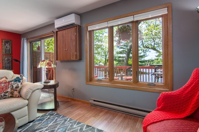 215 Park Dr Unit 4, Balsam Lake, WI 54810 - living room with a baseboard heating unit, a wall unit AC, wood finished floors, and baseboards