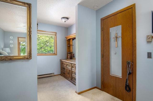 215 Park Dr Unit 4, Balsam Lake, WI 54810 - corridor featuring a baseboard radiator, light carpet, and baseboards
