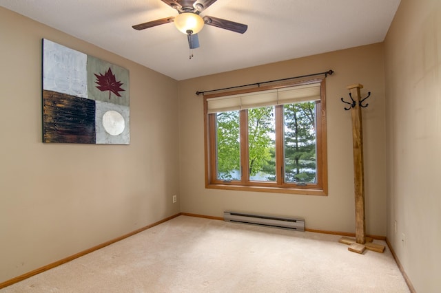 215 Park Dr Unit 4, Balsam Lake, WI 54810 - carpeted empty room with a baseboard heating unit, baseboards, and a ceiling fan