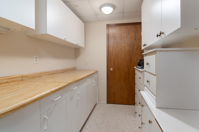215 Park Dr Unit 4, Balsam Lake, WI 54810 - kitchen with a drop ceiling, white cabinets, light carpet, and light countertops