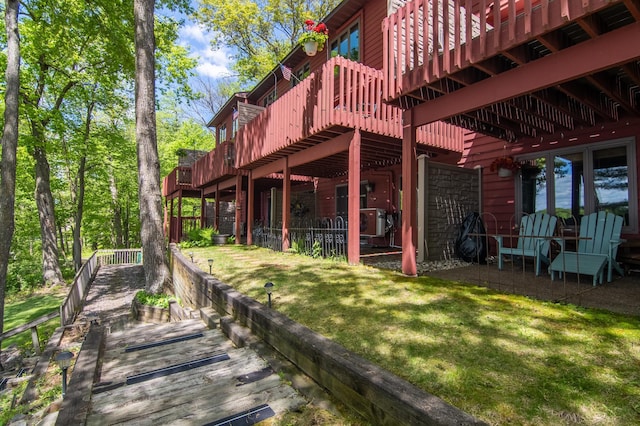 215 Park Dr Unit 4, Balsam Lake, WI 54810 - rear view of property with a wooden deck and a yard
