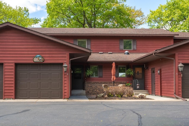 215 Park Dr Unit 4, Balsam Lake, WI 54810 - view of front of house with roof with shingles and a garage